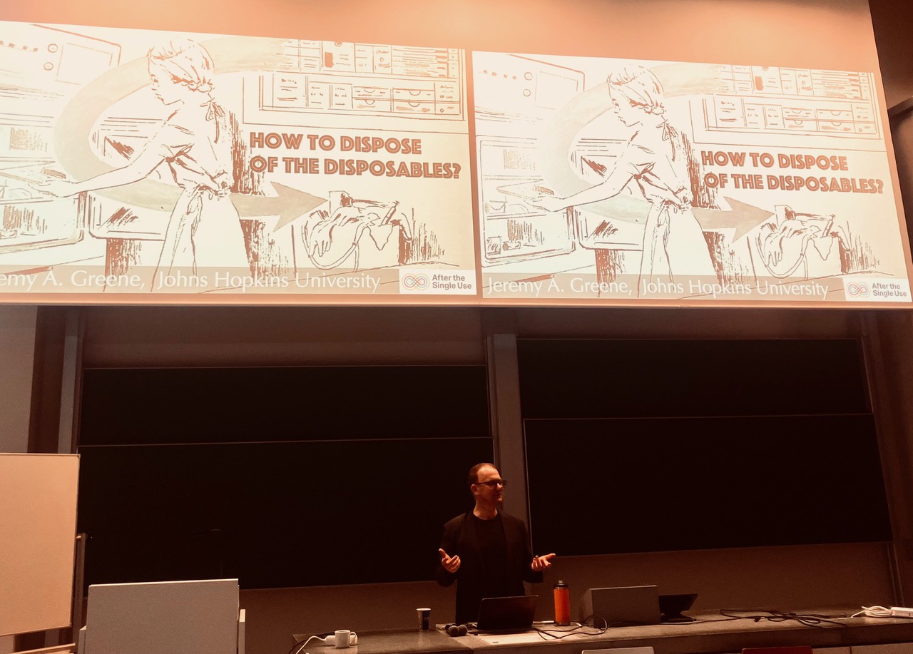 Jeremy presenting his paper with a historical image on the screen behind him