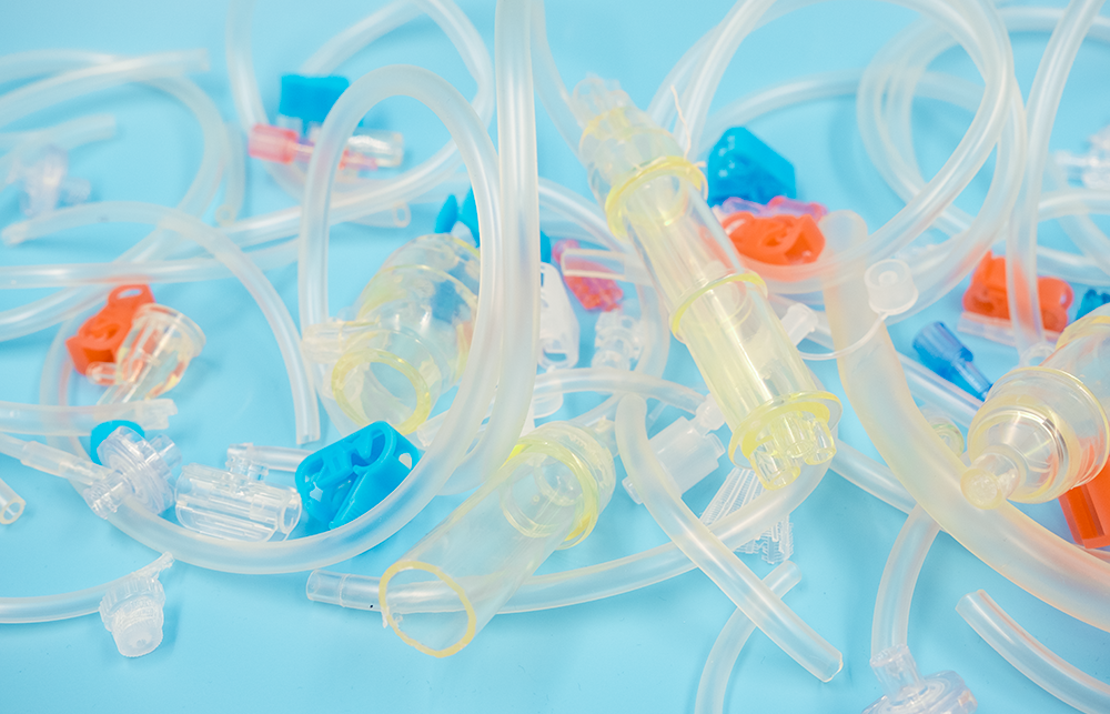 Plastic parts of diagnostic devices are placed on a blue background. 