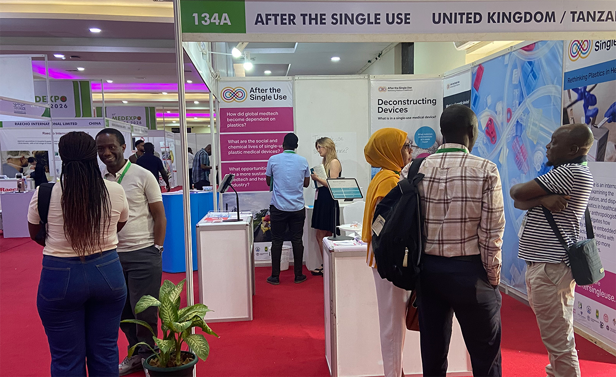 A busy booth at MedExpo Africa, three small groups of people are talking around different displays. 