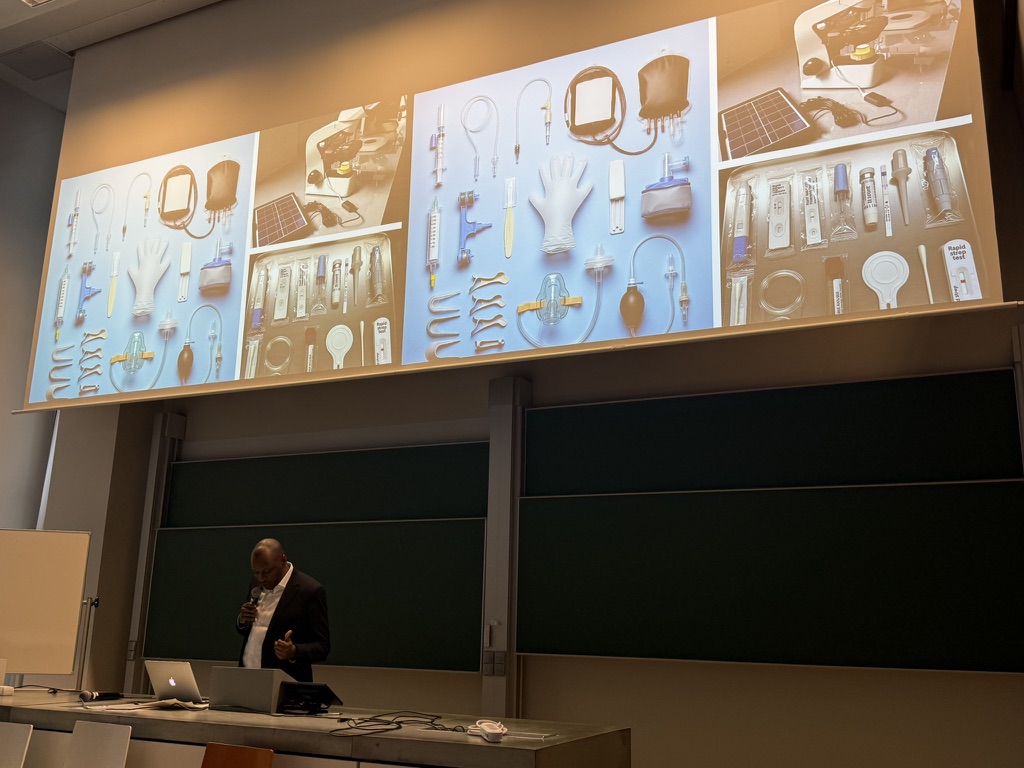 Peter presents his paper with images of single-use medical devices on the screen behind him