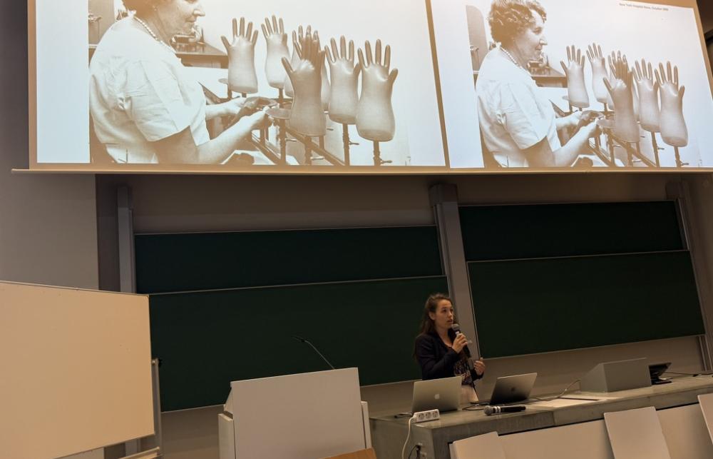 Eloise presenting with images from historical archives on the screen behind her.