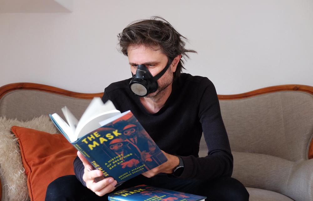 Bruno Strasser reads his book The Mask while wearing a mask.